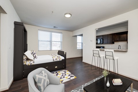 a bedroom with a bed and a living room with a kitchen